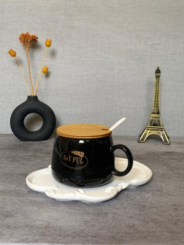 Black mug with wooden lid and spoon